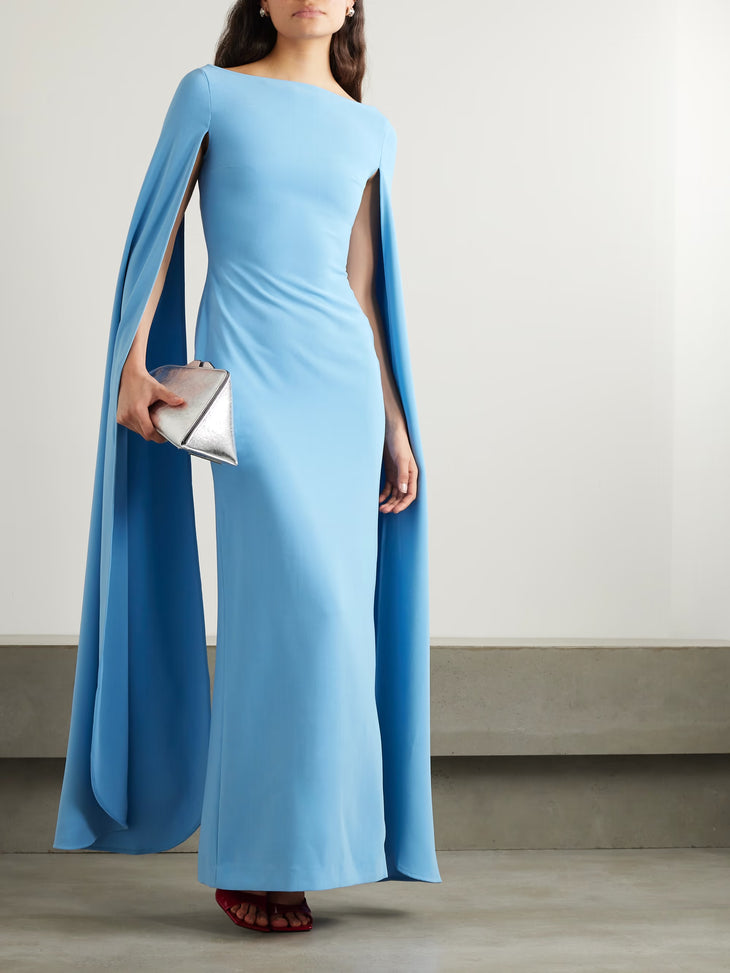 Light blue floor-length gown with dramatic cape sleeves and fitted silhouette — Solace London | Endless UAE