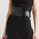 Black laser-cut leather waist belt with scalloped edges and decorative perforations, worn with black dress — Alaïa | Endless UAE