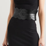 Black laser-cut leather waist belt with scalloped edges and decorative perforations, worn with black dress — Alaïa | Endless UAE