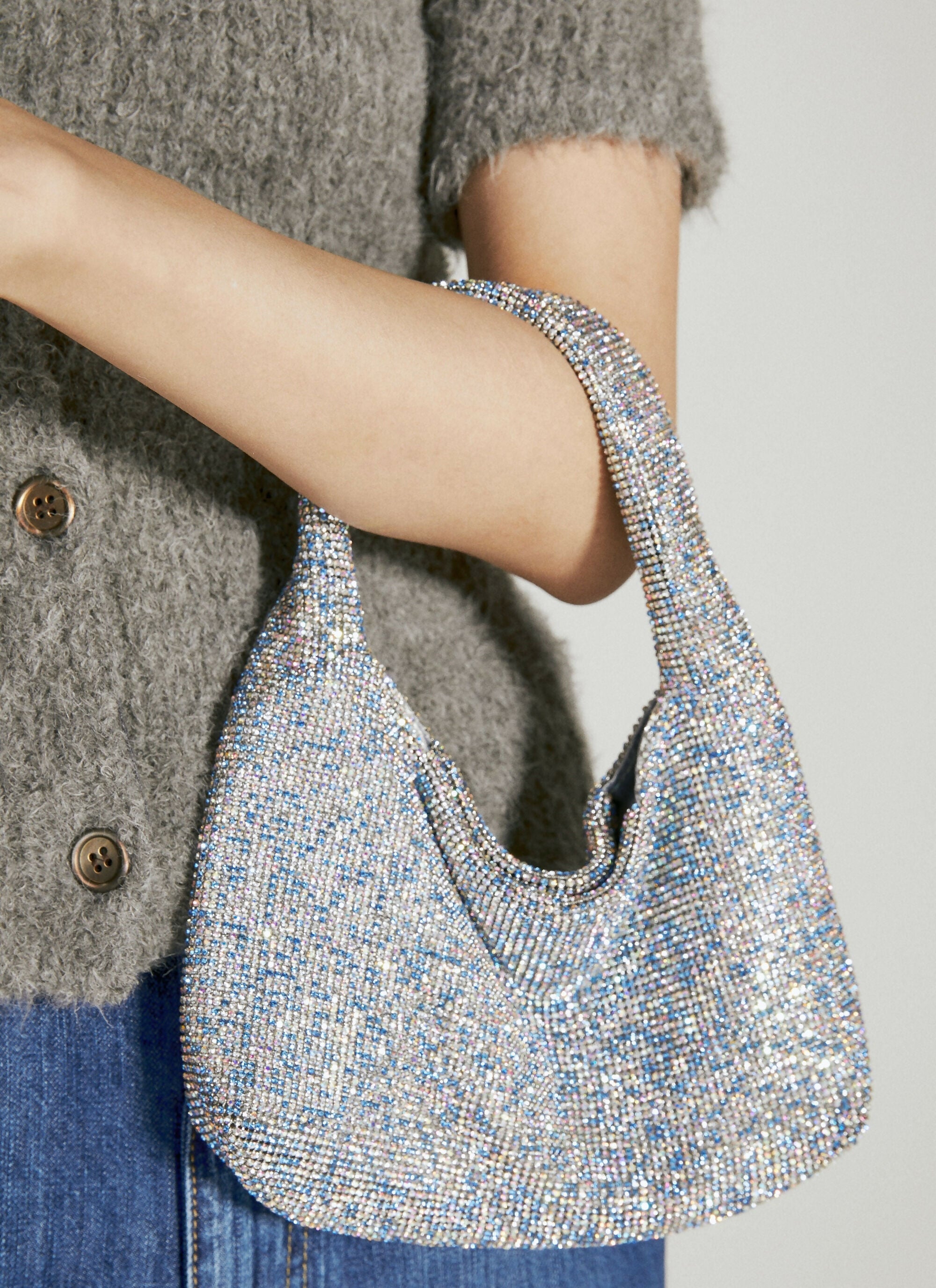 Mini crystal mesh shoulder bag in blue and silver tones with beaded strap worn over gray cardigan — KARA | Endless UAE