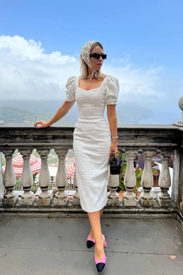 White textured midi dress with puff sleeves and square neckline styled with pink heels — Post Meridiem | Endless UAE