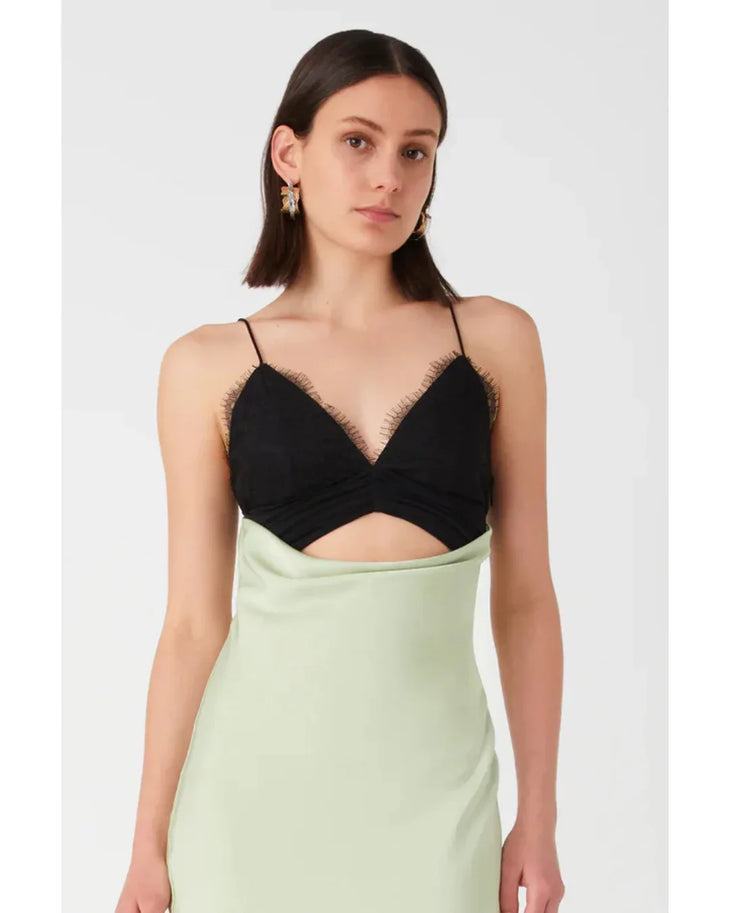 Woman wearing black and sage green color-block satin maxi dress with cutout detail — Misha | Endless UAE