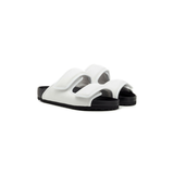White padded dual-strap slide sandals with black soles and velcro closures — 1774 Birkenstock | Endless UAE