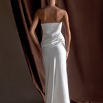 Woman in elegant white strapless satin maxi dress with sleek silhouette and floor-length hem — Meshki | Endless UAE