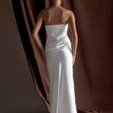 Woman in elegant white strapless satin maxi dress with sleek silhouette and floor-length hem — Meshki | Endless UAE