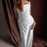 Woman wearing elegant white strapless satin maxi dress with structured bodice and flowing skirt — Meshki | Endless UAE