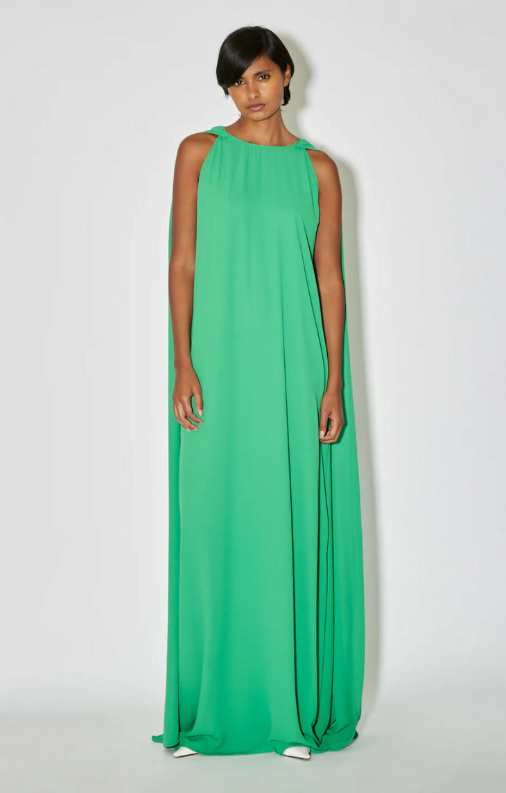 Woman wearing floor-length sleeveless green dress with high neckline and flowing silhouette — Bernadette | Endless UAE