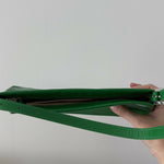 Dulce Patent Leather Shoulder Bag in vibrant green, held up against neutral background — By Far | Endless UAE