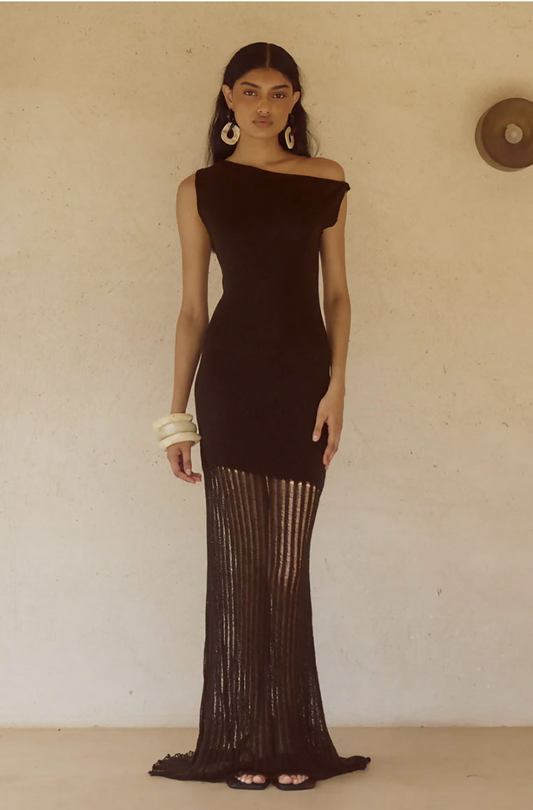 Woman wearing black off-shoulder knit maxi dress with fringe hem and white bangles — Endless | Endless UAE