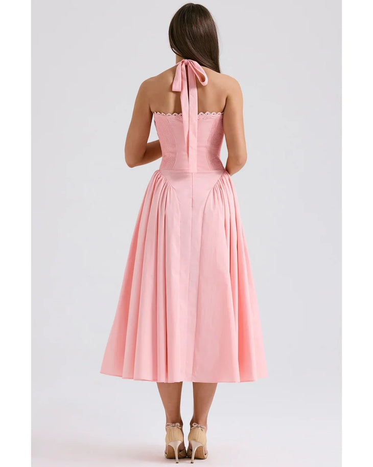 Woman wearing rose pink cotton halter midi sundress with ruched neckline and full skirt — House of CB | Endless UAE
