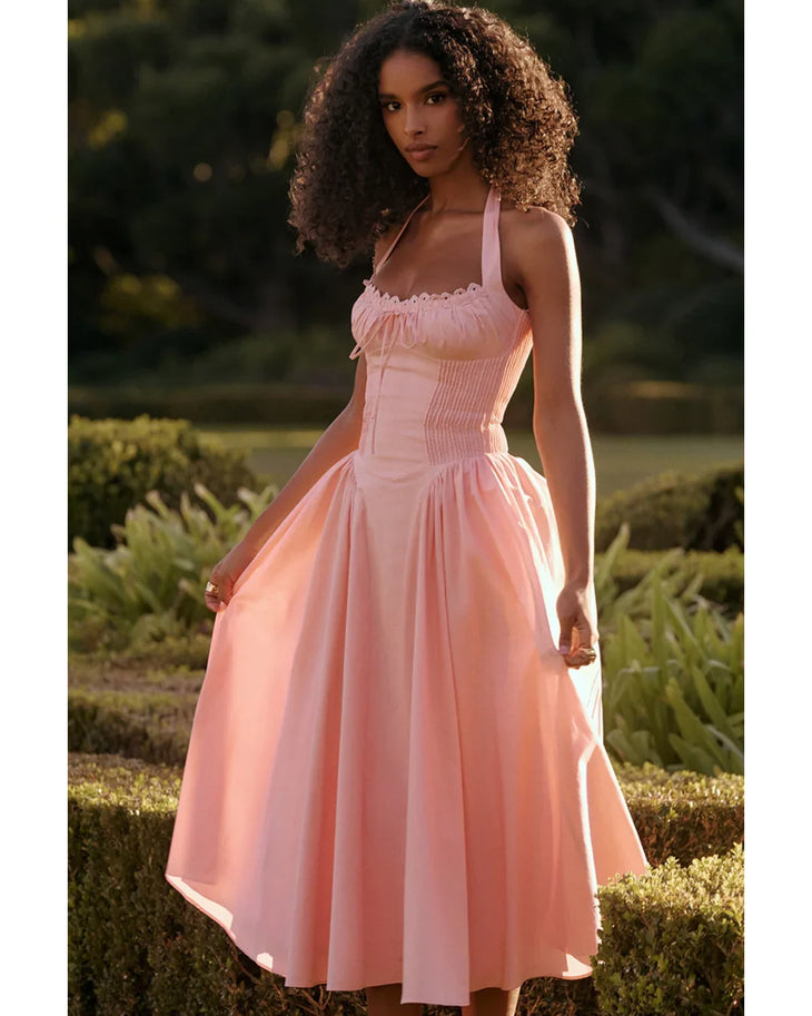 Woman wearing rose pink cotton halter midi sundress with ruched neckline and full skirt — House of CB | Endless UAE
