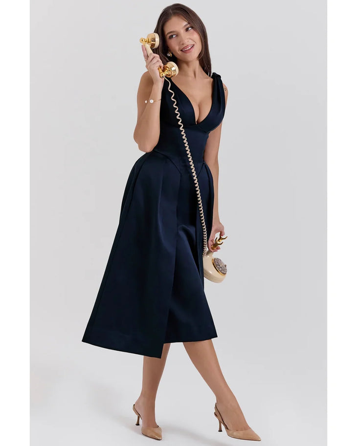 Woman wearing navy blue satin midi dress with twisted shoulder straps and full skirt — House of CB | Endless UAE