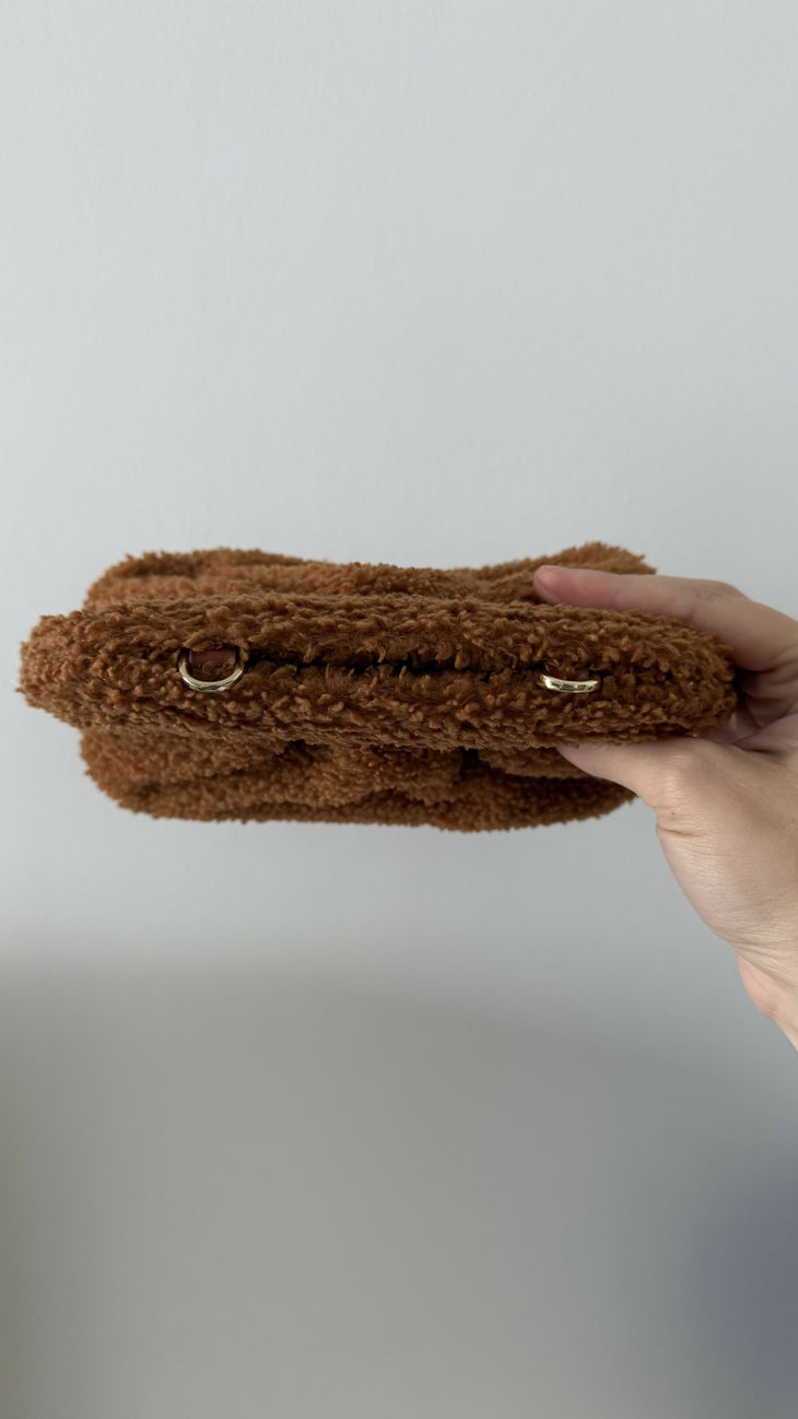 Gea Clutch in caramel brown textured fabric held in hand — TheMoire | Endless UAE