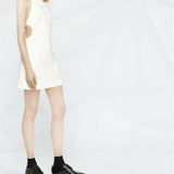 White sleeveless mini dress with side cutouts paired with black platform shoes — Courrèges | Endless UAE