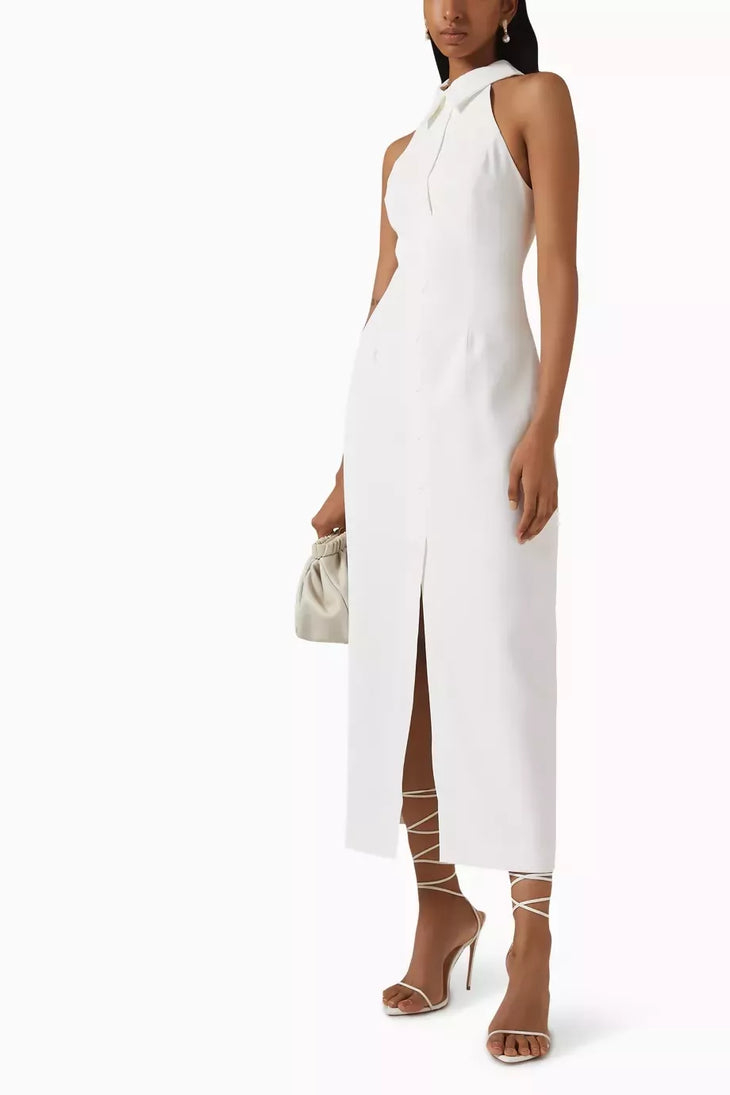Woman wearing white sleeveless halter maxi dress with front slit and white strappy heels — Odd Muse | Endless UAE