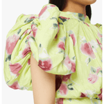 Woman wearing yellow floral puff-sleeve top with white midi skirt and blue sandals — Rotate Birger Christensen | Endless UAE