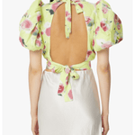 Woman wearing yellow floral puff-sleeve top with white midi skirt and blue sandals — Rotate Birger Christensen | Endless UAE