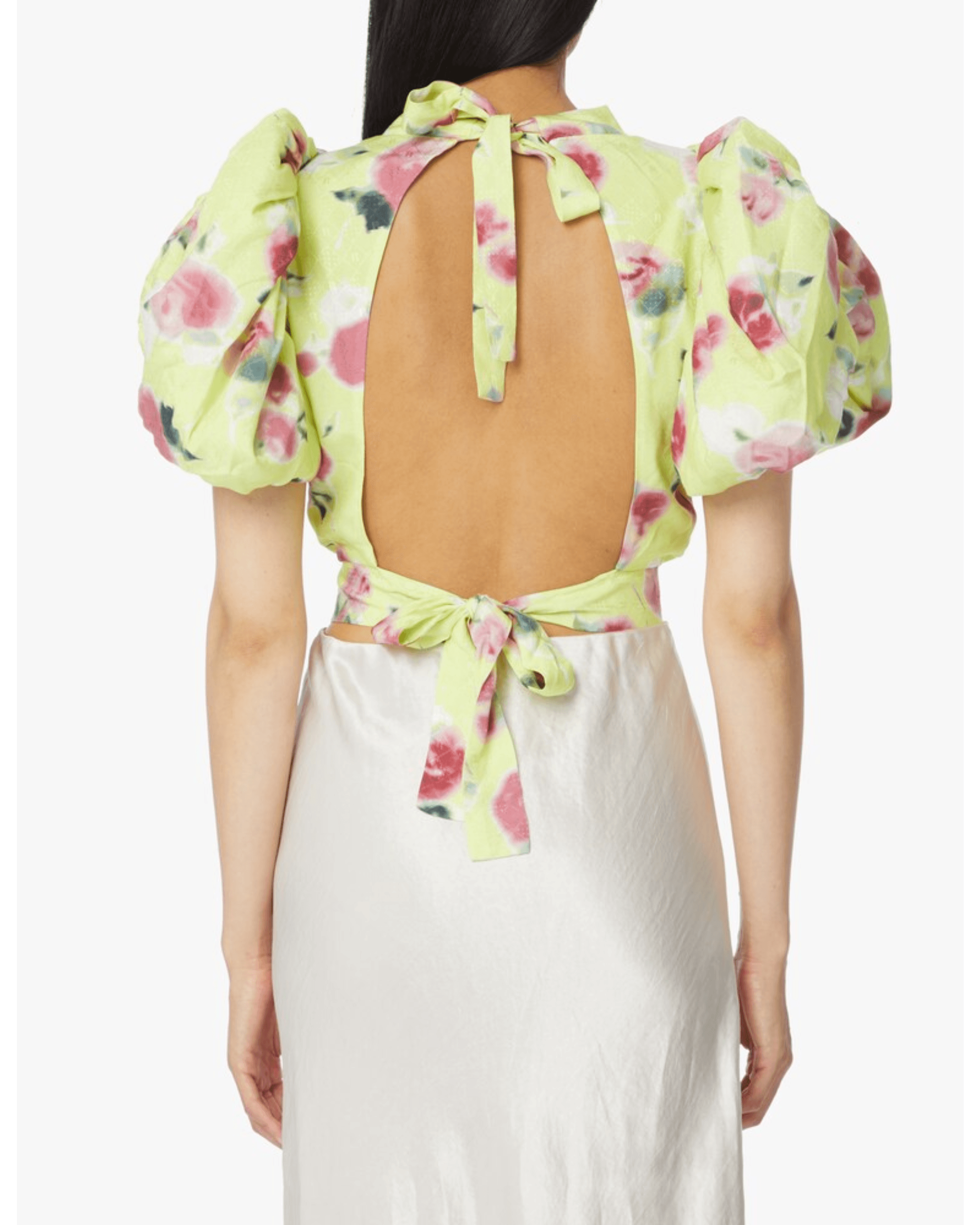 Woman wearing yellow floral puff-sleeve top with white midi skirt and blue sandals — Rotate Birger Christensen | Endless UAE