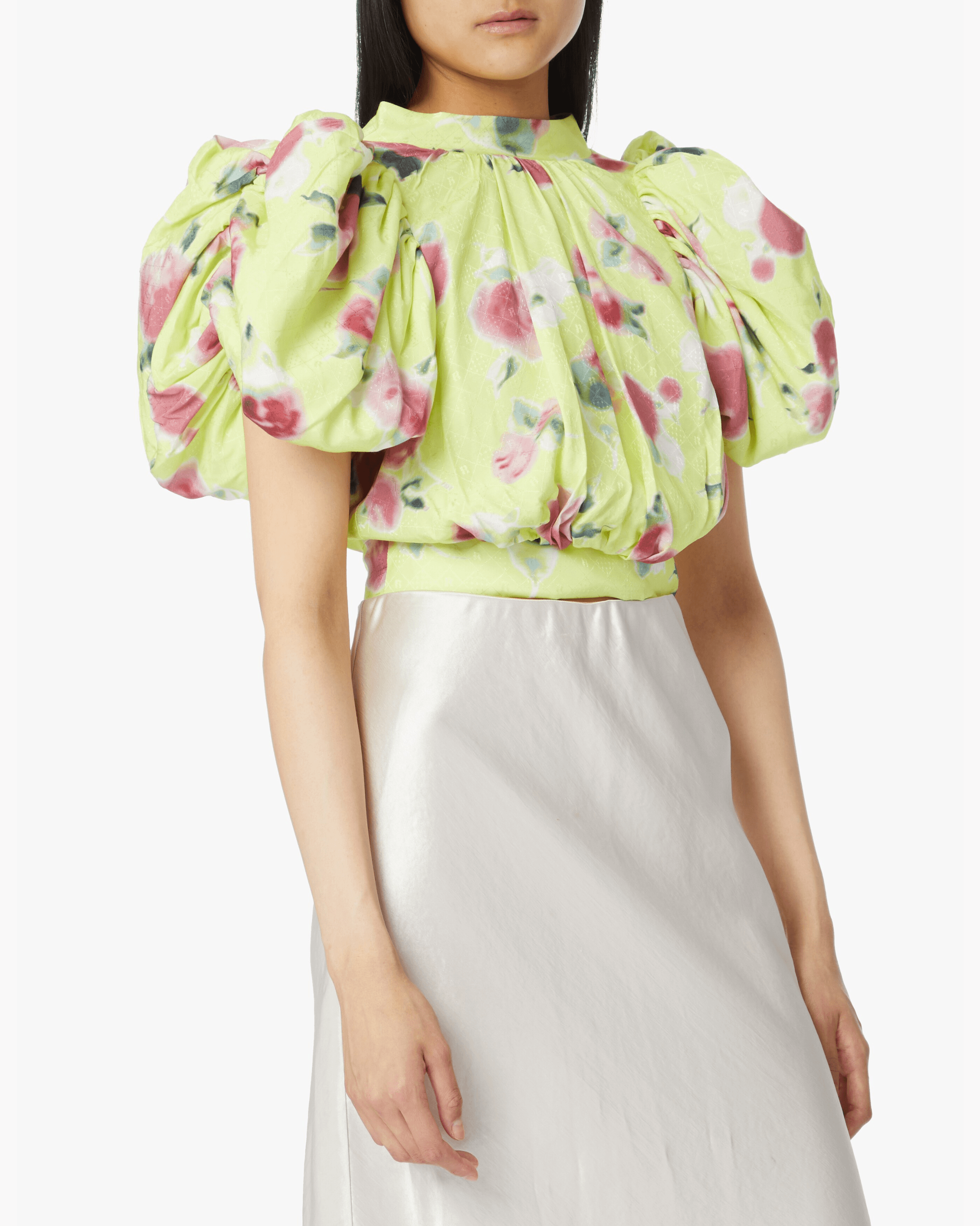Woman wearing yellow floral puff-sleeve top with white midi skirt and blue sandals — Rotate Birger Christensen | Endless UAE