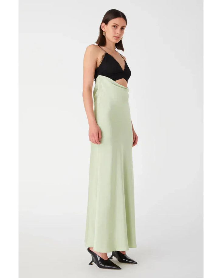 Woman wearing black and sage green color-block satin maxi dress with cutout detail — Misha | Endless UAE