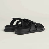 Black leather fisherman sandals with woven straps and adjustable buckle closure on treaded rubber sole — Hermes | Endless UAE