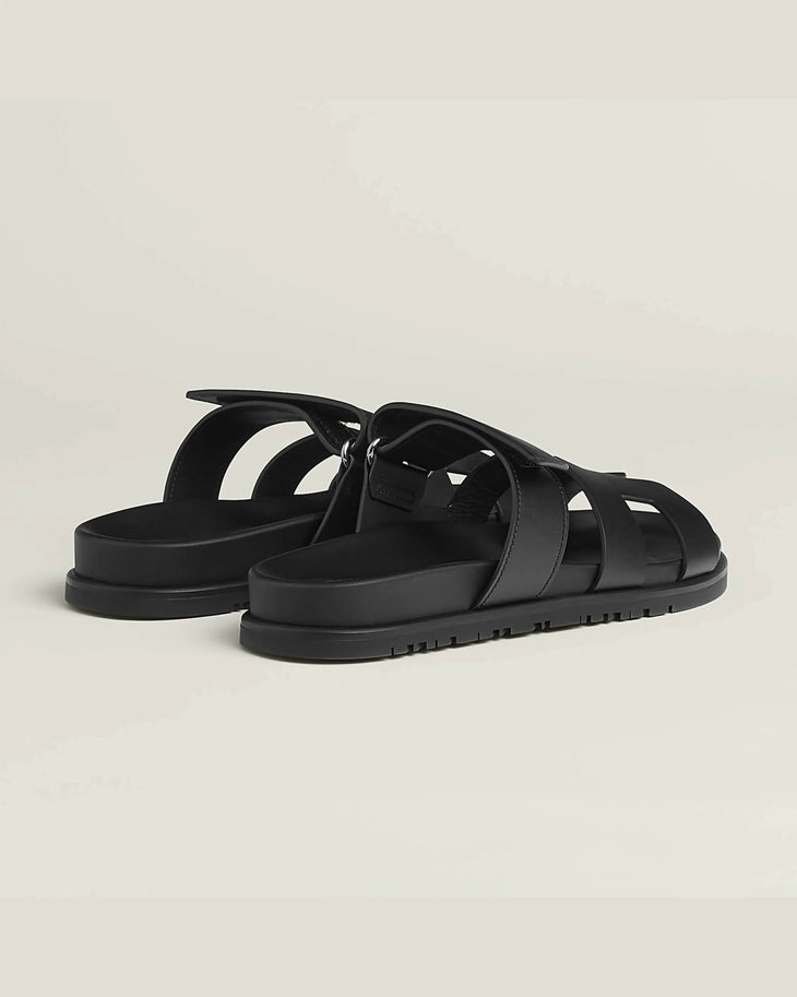 Black leather fisherman sandals with woven straps and adjustable buckle closure on treaded rubber sole — Hermes | Endless UAE