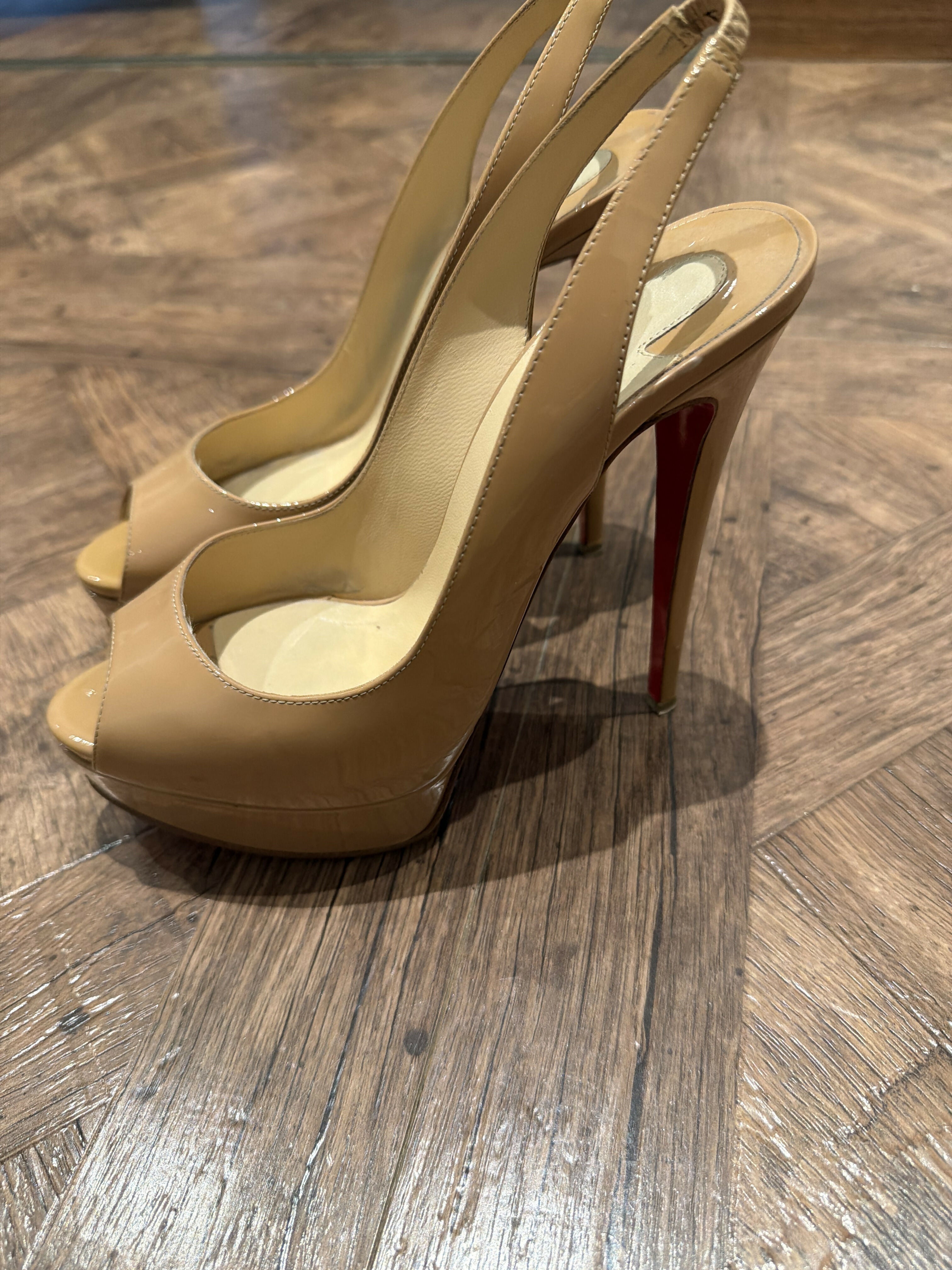 Nude patent leather peep-toe sling-back pumps with red sole — Christian Louboutin | Endless UAE
