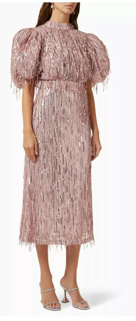 Woman wearing a dusty pink sequin fringe midi dress with puffed sleeves — Endless | Endless UAE