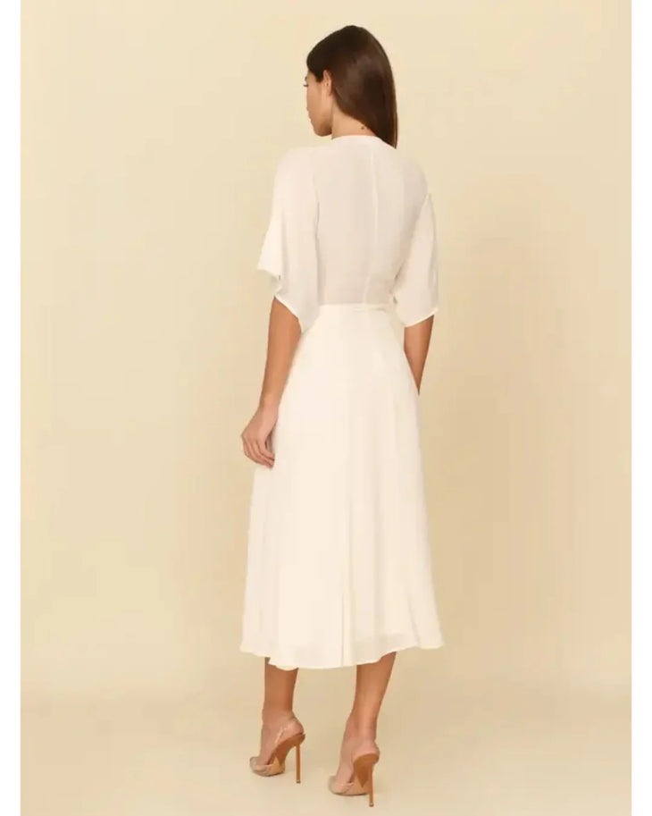 White midi dress with short sleeves and belted waist, shown from back view — Reformation | Endless UAE
