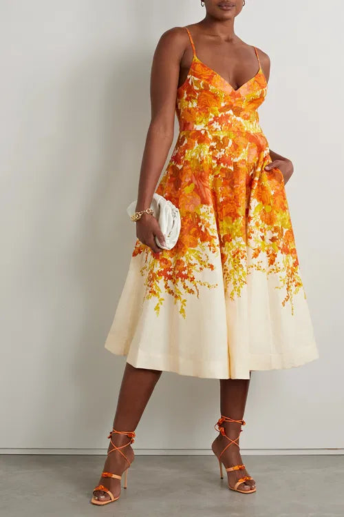 Woman wearing orange and yellow floral-print midi dress with spaghetti straps and fit-and-flare silhouette — Zimmermann | Endless UAE