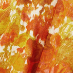 Close-up of vibrant orange and yellow floral-print linen fabric with painterly brushstroke pattern — Zimmermann | Endless UAE