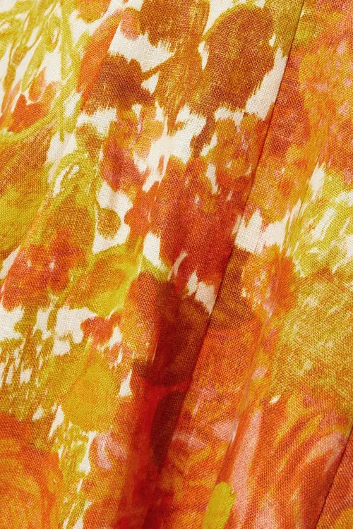 Close-up of vibrant orange and yellow floral-print linen fabric with painterly brushstroke pattern — Zimmermann | Endless UAE