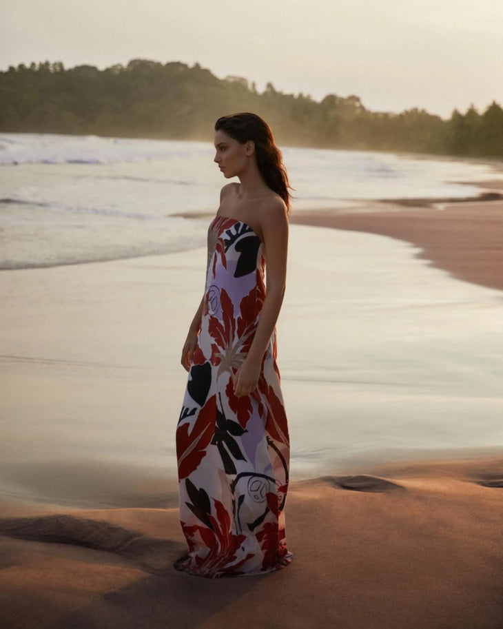 Woman wearing red and white floral maxi dress standing in modern corridor — Second Summer | Endless UAE