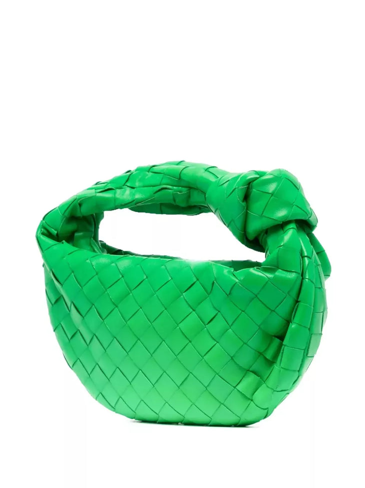 Bright green leather hobo bag held by model in white ribbed tank and black wide-leg pants — Bottega Veneta | Endless UAE