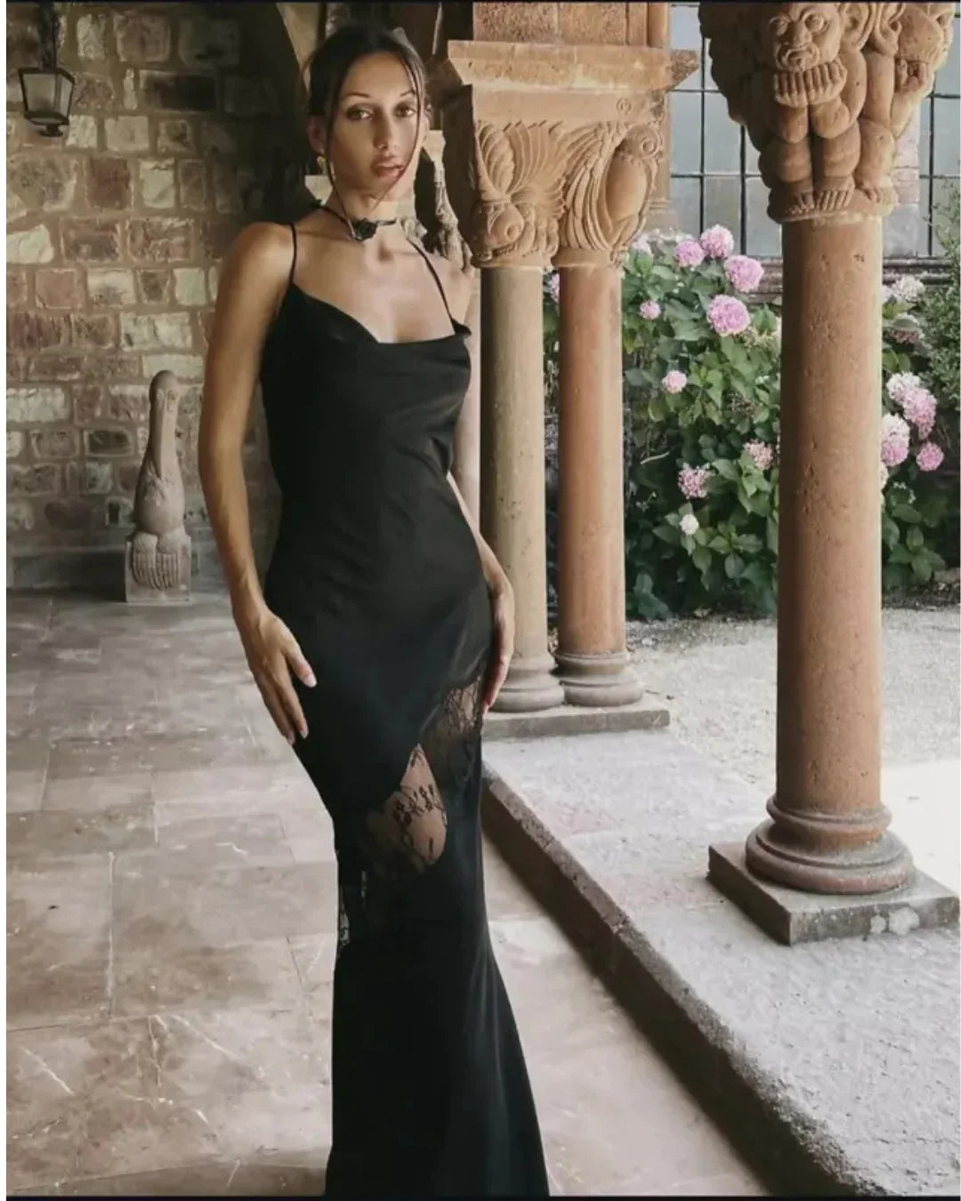 Woman wearing black satin maxi dress with lace side detail and halter neckline — Meshki | Endless UAE